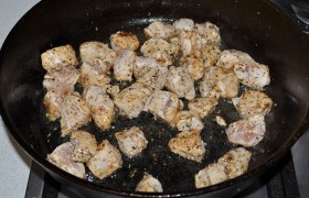 2 ст. ложки масла вливаем в толстодонную сковороду, на сильном огне оно перекалится за 4-5 минут. Выкладываем кусочки филе, помешивая и переворачивая лопаткой, обжариваем буквально минуту-полторы. Как только мясные кусочки побелели – убираем их на тарелку.