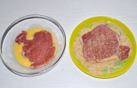 Не забываем за час-полтора до жарки поставить контейнер на стол, чтобы мясо согрелось. Взбиваем яйца со сливками, а сухари тщательно смешиваем с мелко тертым сыром (того и другого - в примерно равных количествах). Искупав отбивную в яйцах, панируем , хорошо прижимая, в сухарях с сыром.