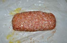 Поднимаем одну сторону бумаги, затем вторую, соединяем края фарша, хорошо заделываем шов и концы рулета.